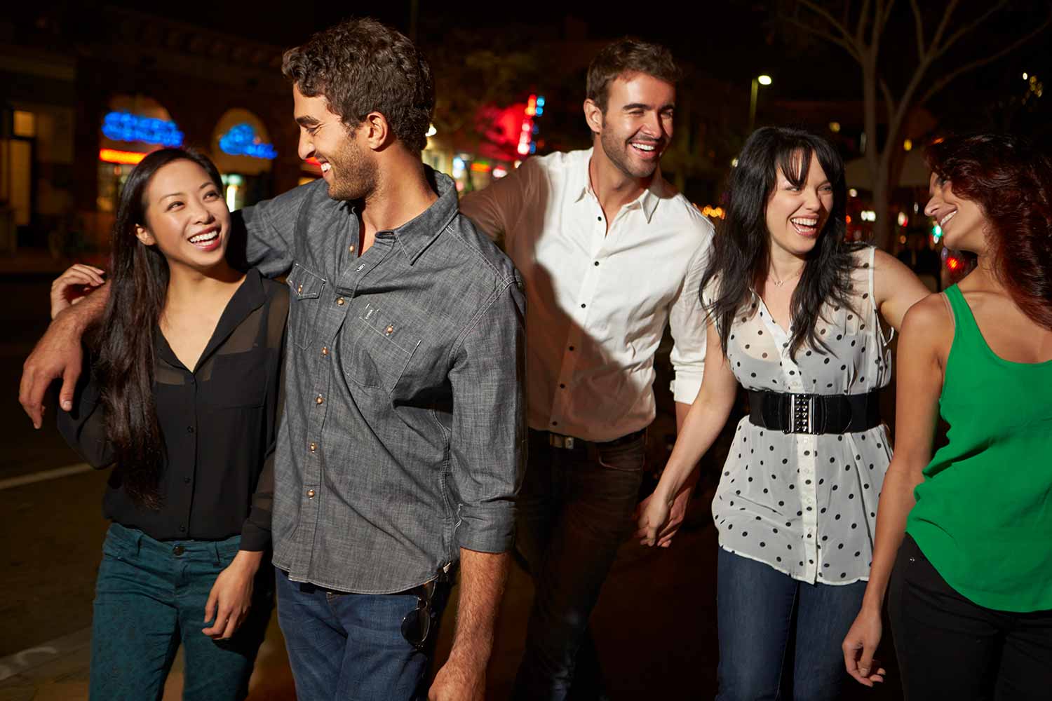 Group of friends laughing and enjoying a night out in Calgary