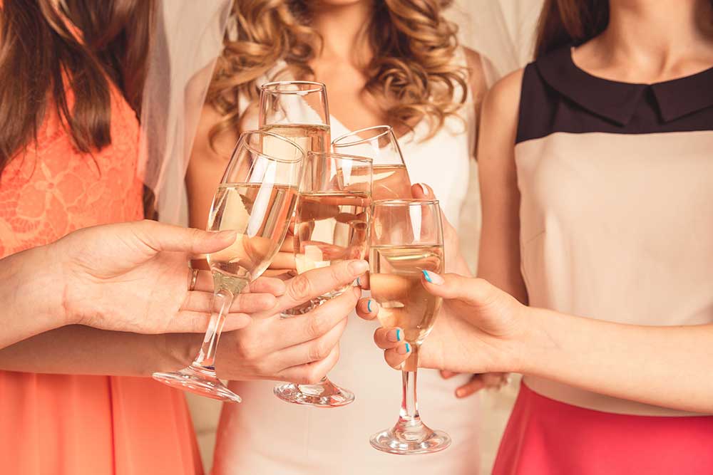 Friends raising glasses during a bachelorette party