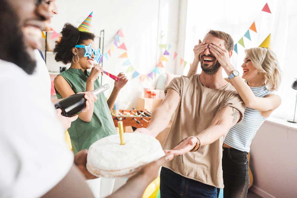 Friends surprising someone with a birthday cake