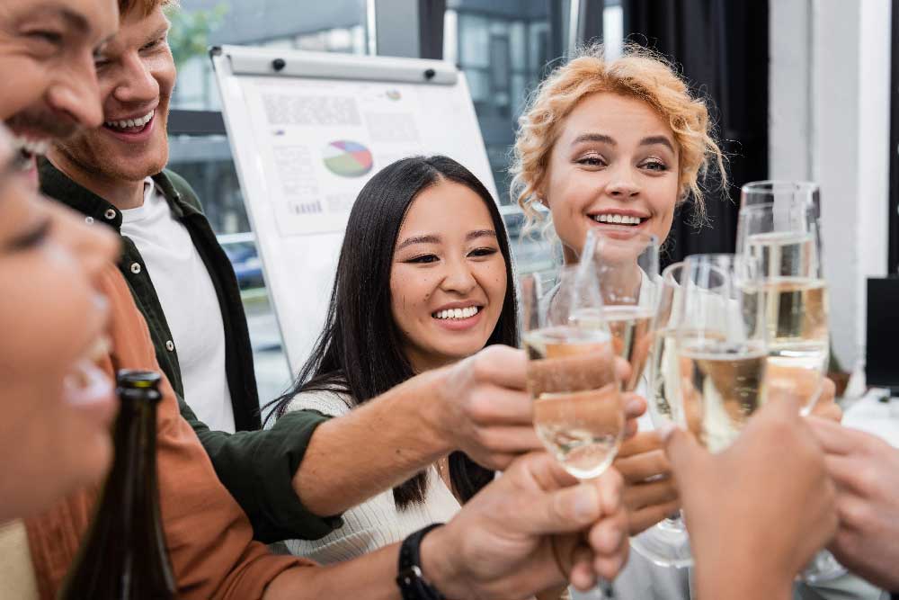 Coworkers raising glasses during a corporate celebration