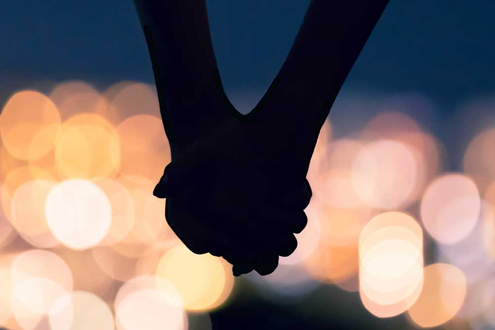 Couple holding hands during a date night