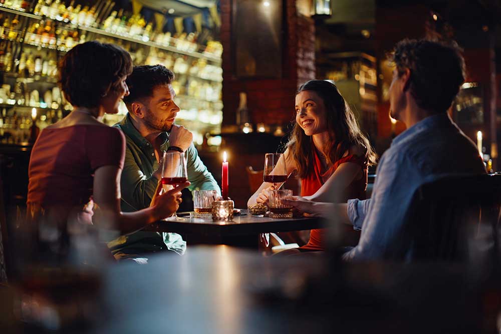Friends enjoying drinks together during a night out