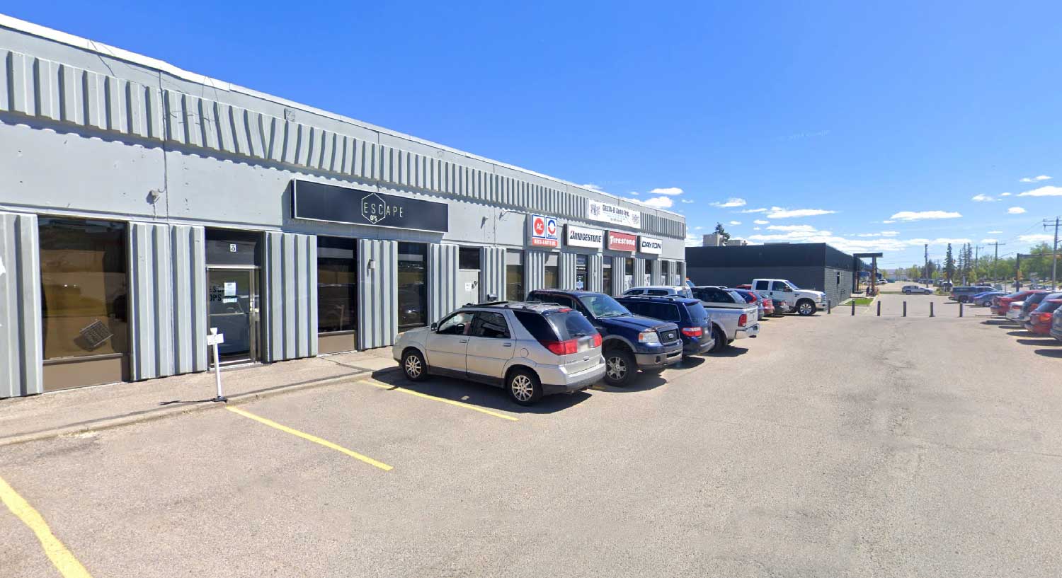Exterior of Escape Ops Calgary with storefront parking