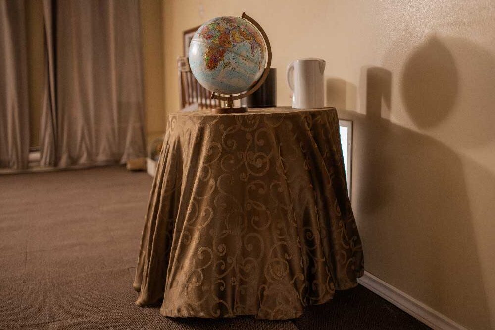 Room decor with a lamp and globe inside the Ops Cognition escape room