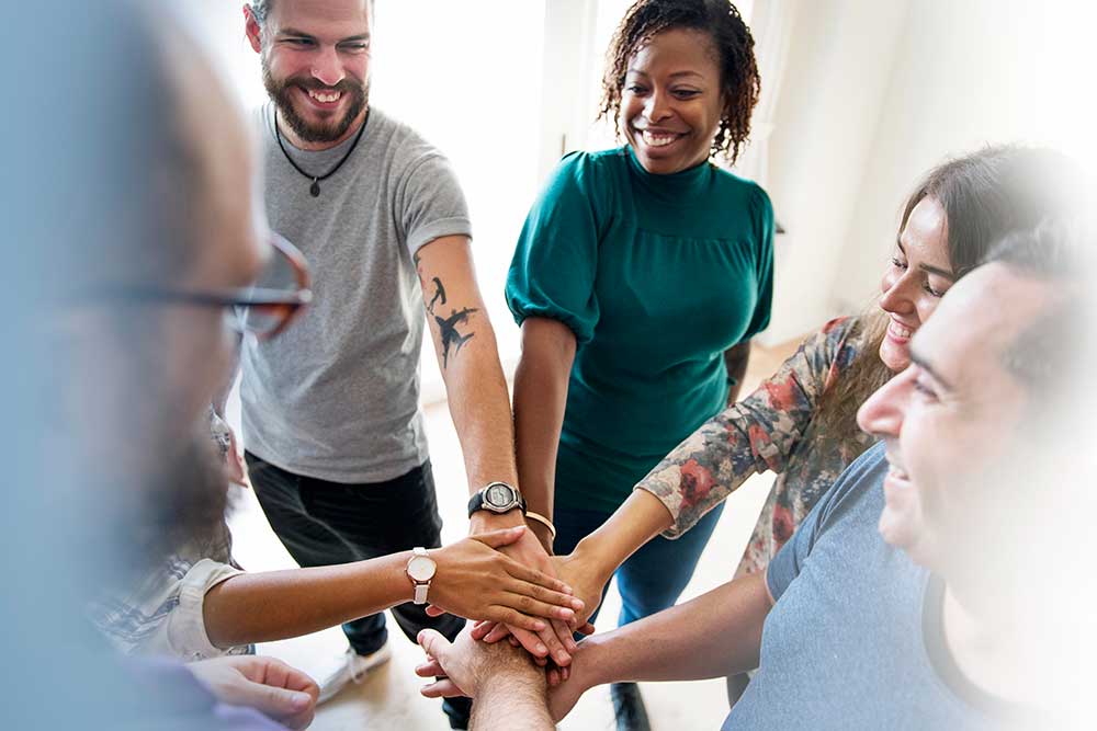 Group stacking hands during a team building activity