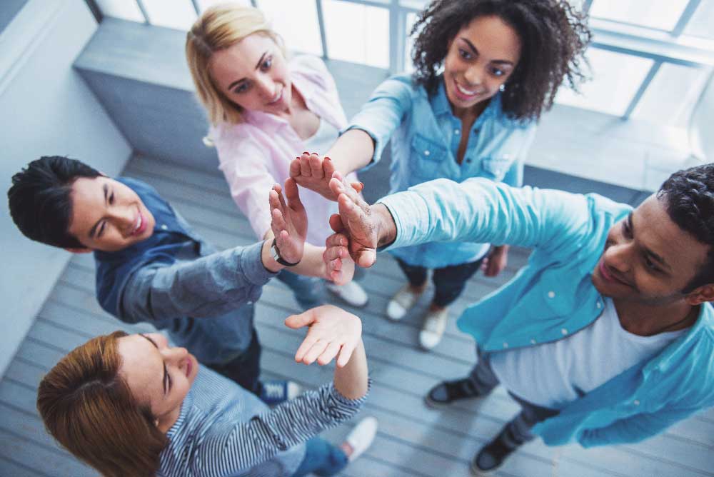 Team high-fiving during a group team building activity