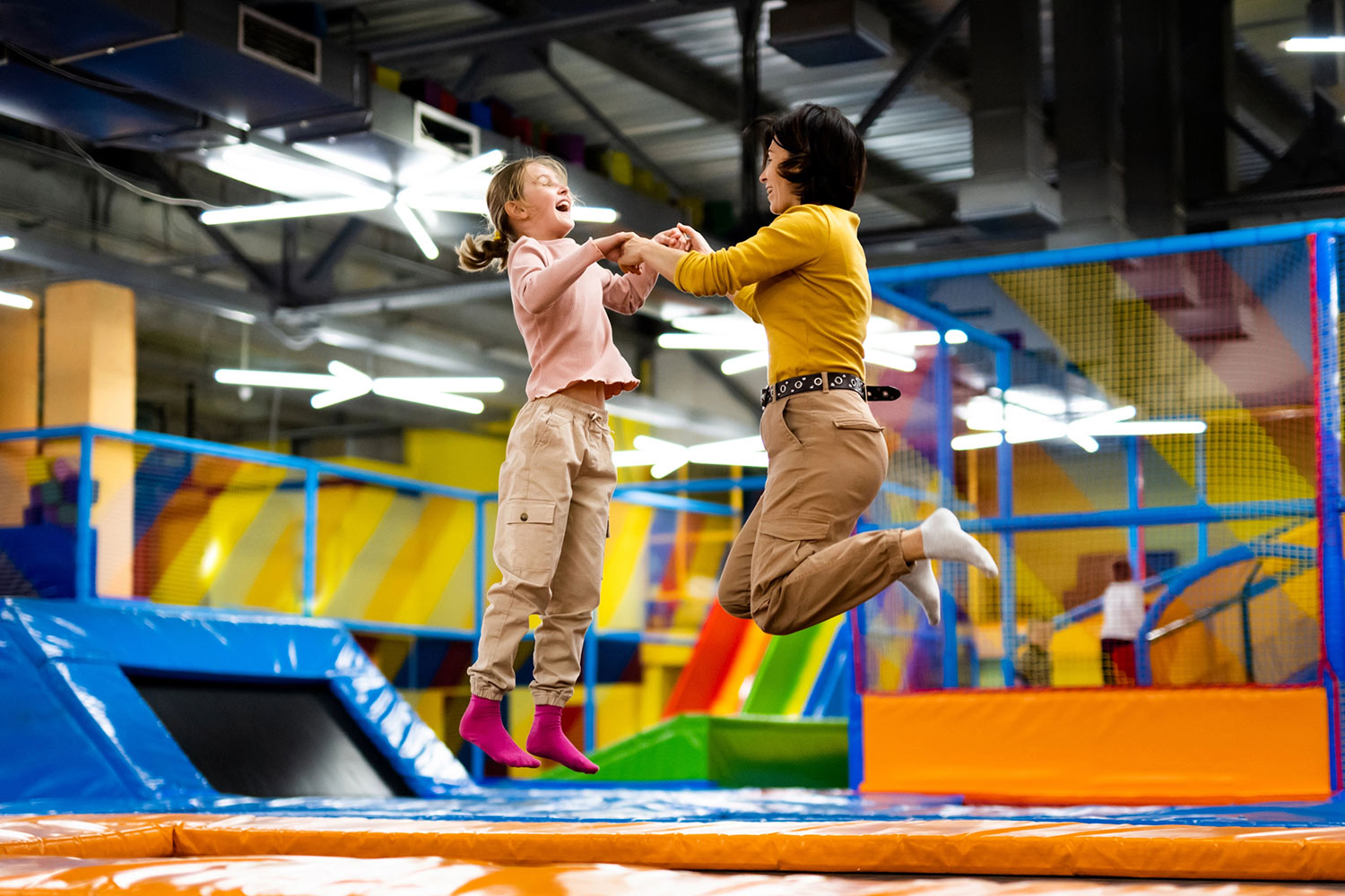 mom and daughter jumping at an indoor trampoline park in Calgary